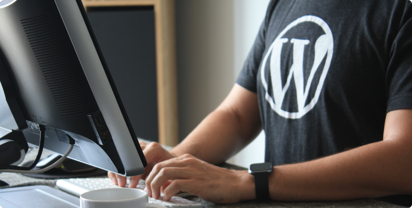 Man sitting at desk with WordPress shirt
