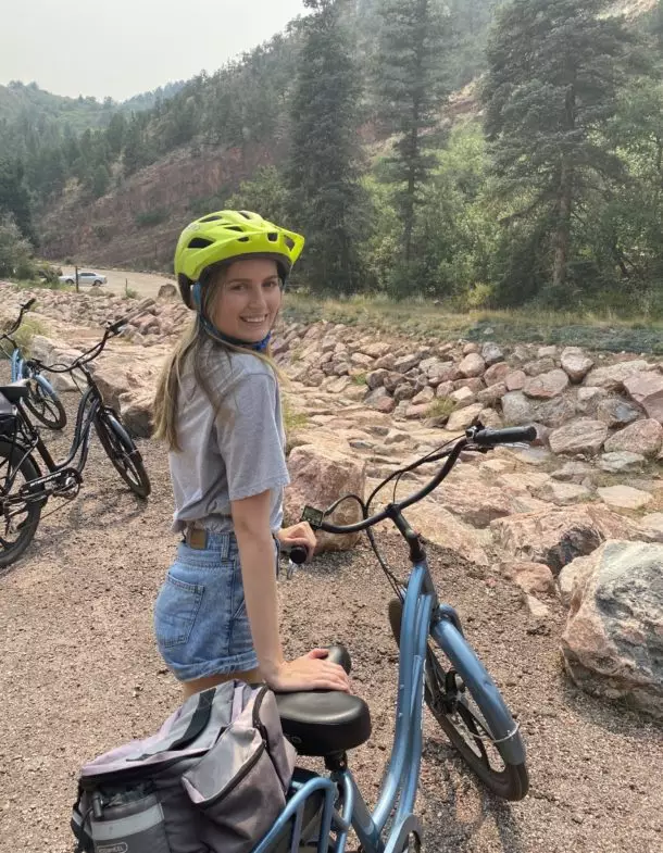 Person in helmet biking on mountain trail